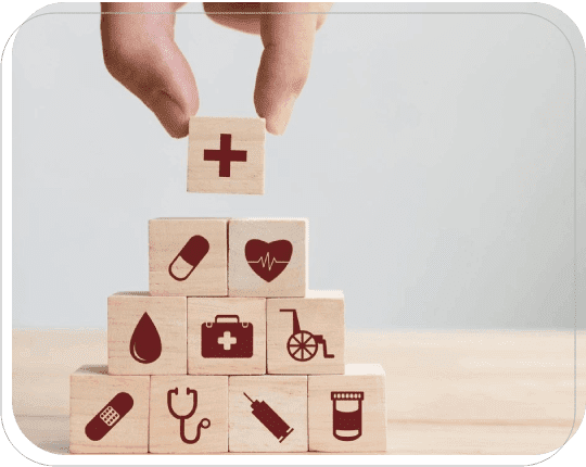 A hand is holding onto blocks with medical symbols on them.