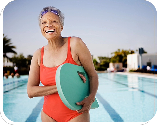 A woman in a red bathing suit holding a blue frisbee.